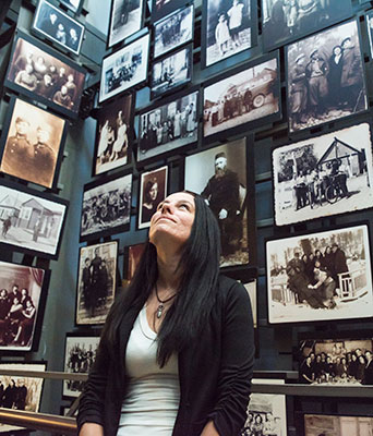 Laura Mahan Laura Mahan surrounded by pictures of Holocaust victims