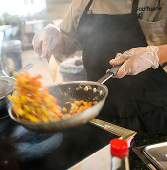 Chef cooks dish in wok Chef cooks dish in wok
