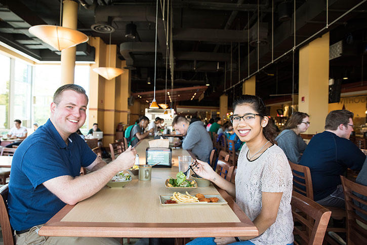 A male and female student enjoy a meal in a Mason dining hall
